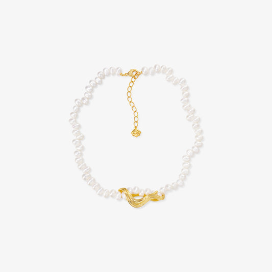 TIKOO original natural white pearl necklace with 18K gold plated sculptural wave pendant on a white background.