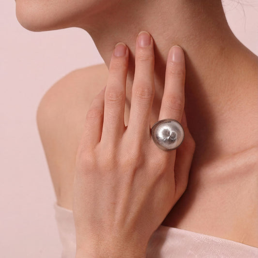 Side view of the TIKOO bold minimalist ring on a model, showcasing its contemporary design and brushed texture.
