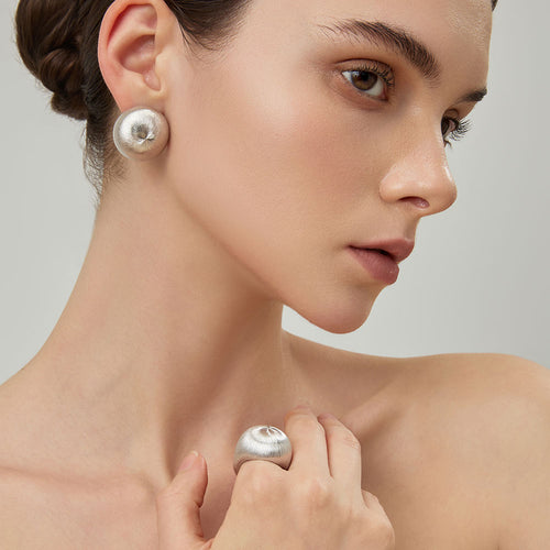 Side view of the TIKOO bold minimalist ring on a model, showcasing its contemporary design and brushed texture.