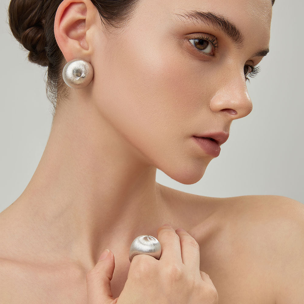 Side view of the TIKOO bold minimalist ring on a model, showcasing its contemporary design and brushed texture.
