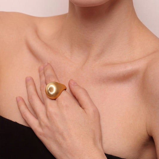 Side view of the thick 18K gold plated dome ring on model, highlighting the quiet luxury aesthetic.