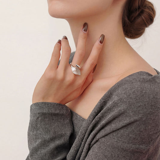 Model wearing TIKOO silver-tone pearl leaf ring with a beige knit sweater for a modern look.