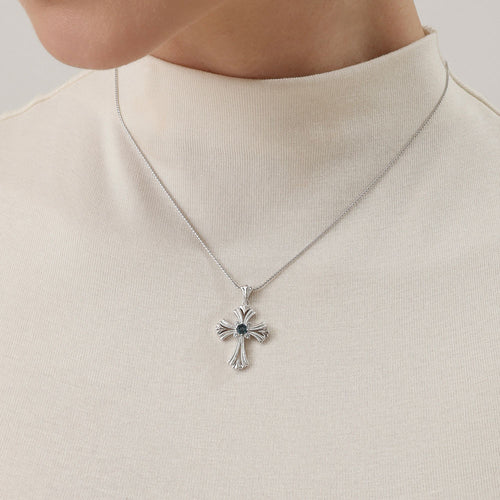 Close-up detail of TIKOO cross necklace showing thick platinum plating and VVS Moissanite sparkle.