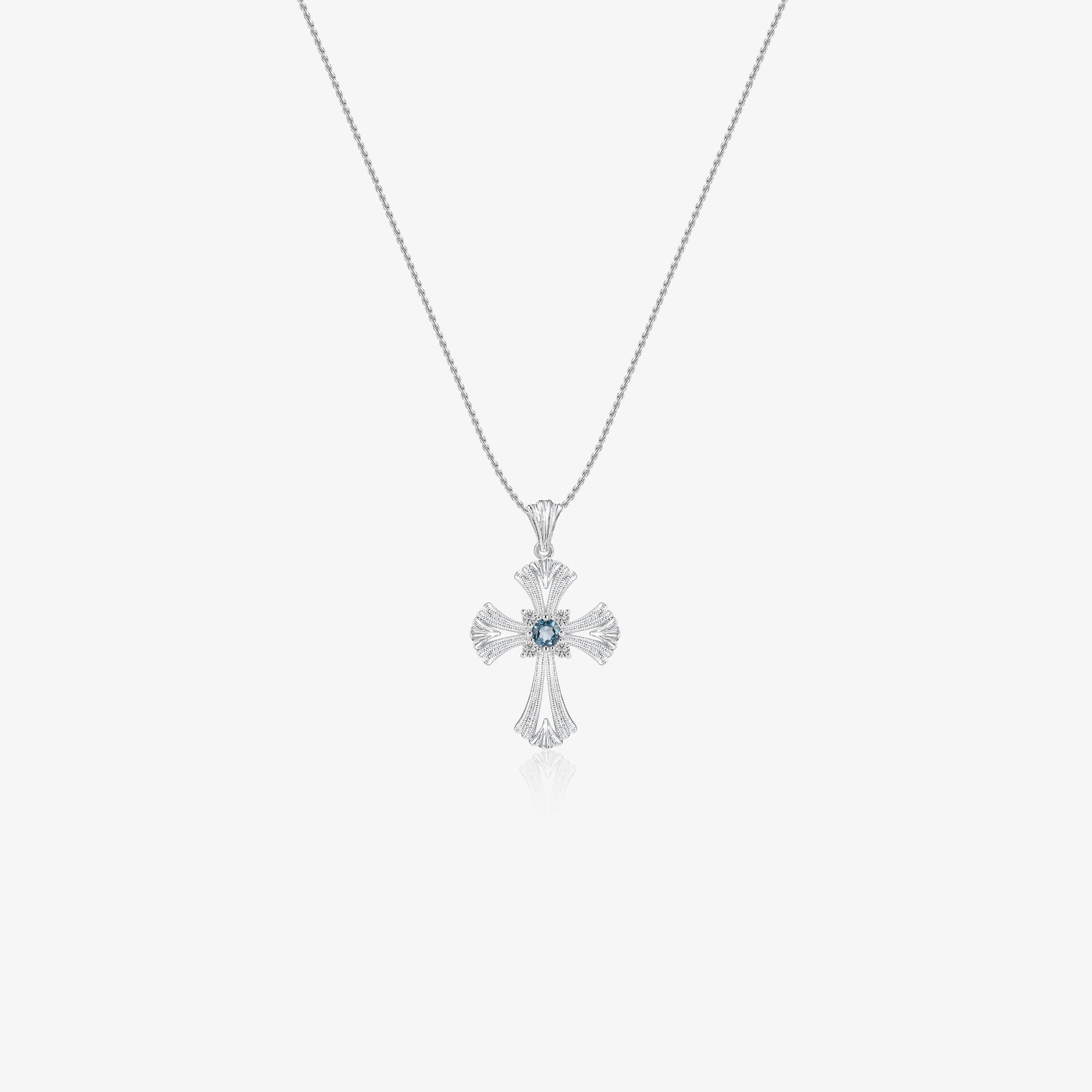TIKOO original cross pendant necklace with a blue topaz center and moissanite accents on white background.