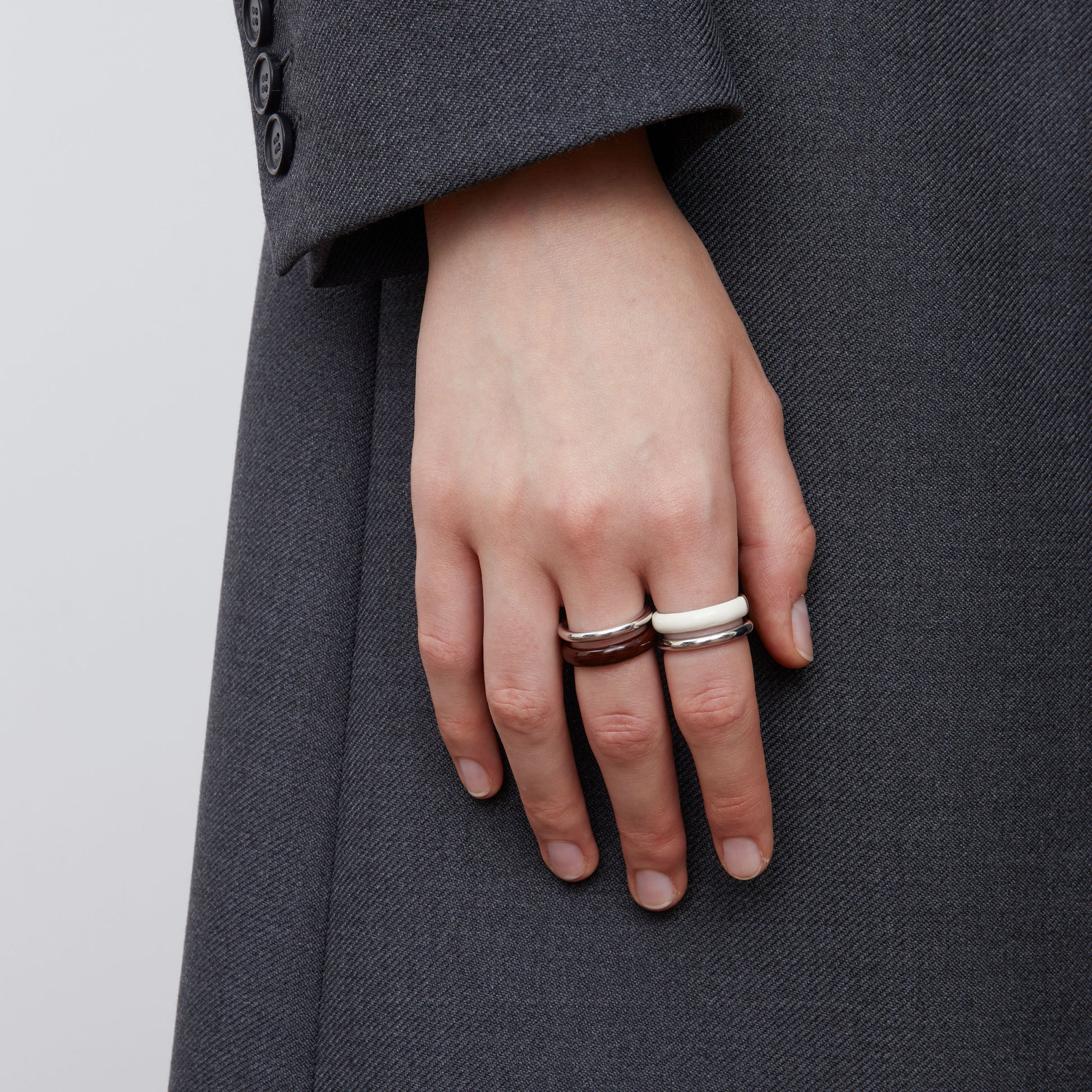 Front view of a model wearing TIKOO minimalist pure white enamel ring for a modern look.