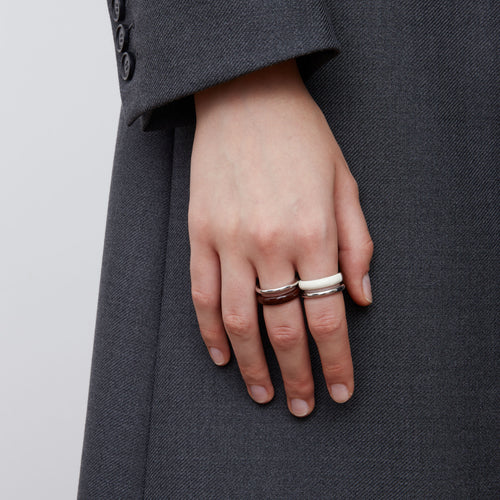 Front view of a model wearing TIKOO minimalist pure white enamel ring for a modern look.