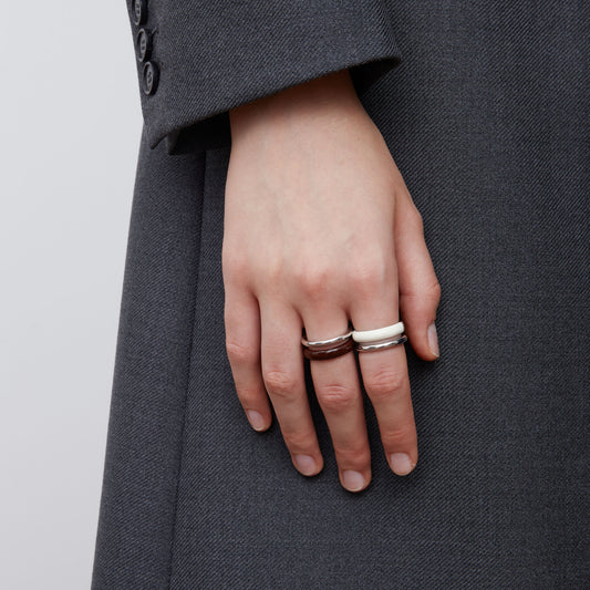 Front view of a model wearing TIKOO minimalist pure white enamel ring for a modern look.