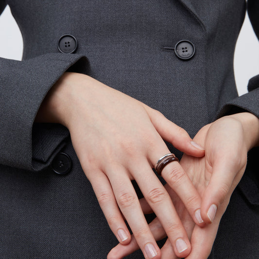 Side view of the TIKOO thick platinum-plated brown enamel ring showcasing its sculptural lines.