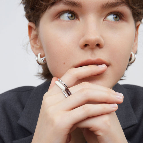 High-definition detailed shot of TIKOO handcrafted white enamel and platinum-plated ring.