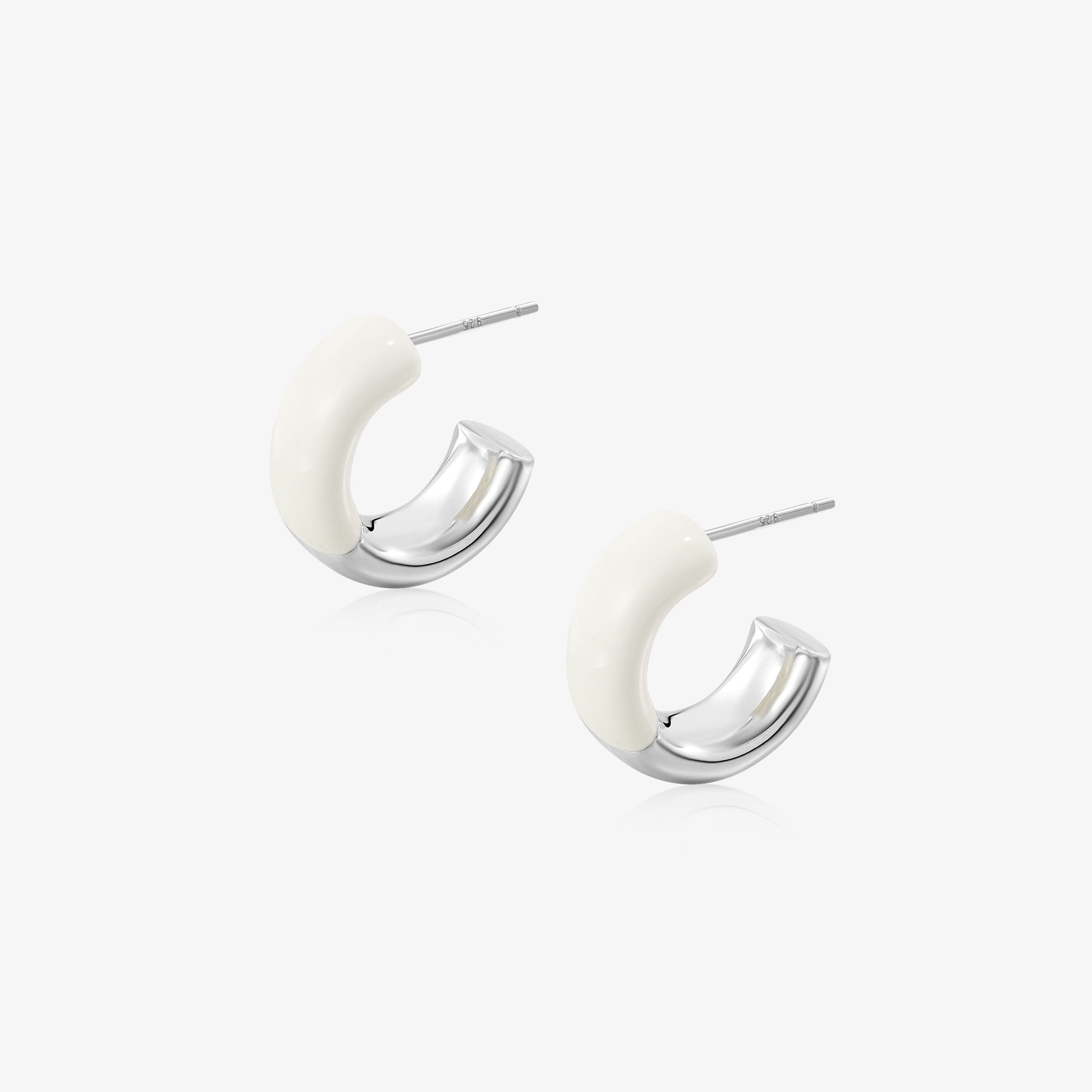TIKOO original white enamel and thick white gold plated C-shaped hoop earrings on white background.