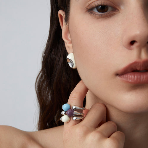 A close-up view of a model wearing the TIKOO white enamel organic ring, highlighting the elegant silver-tone finish.