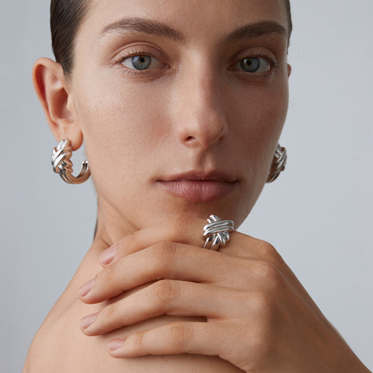 Model wearing the TIKOO statement silver knot ring, highlighting its bold sculptural shape.