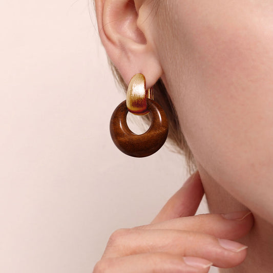 Detailed view of the chatoyant brown tiger eye texture and 18k gold plated finish on TIKOO designer earrings.