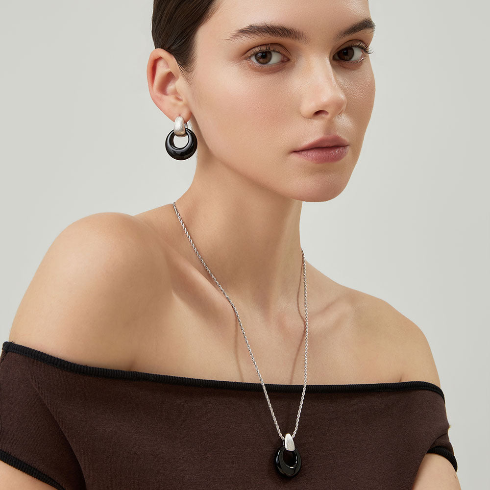 Model wearing TIKOO black onyx pendant necklace, showcasing a professional and minimalist jewelry style.