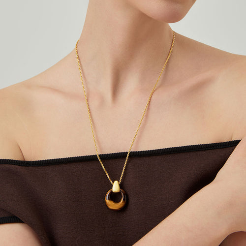 Close-up of a model wearing TIKOO tiger eye necklace for an old money aesthetic.