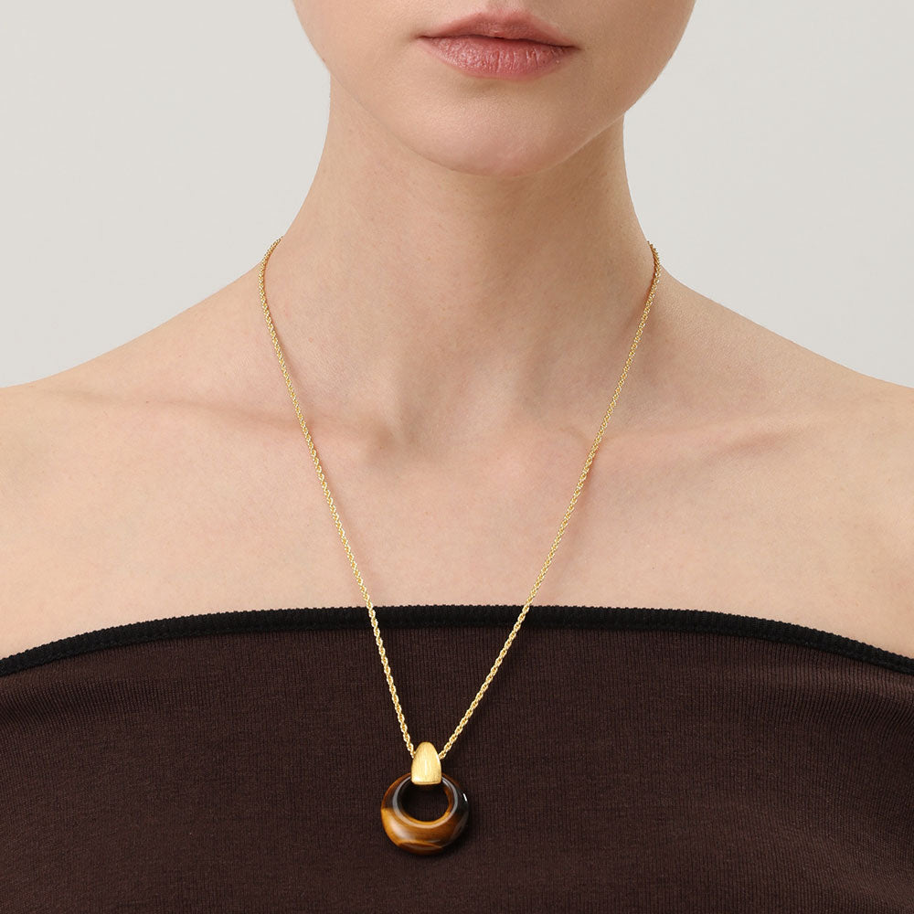Close-up of a model wearing TIKOO tiger eye necklace for an old money aesthetic.