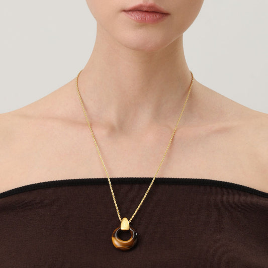 Close-up of a model wearing TIKOO tiger eye necklace for an old money aesthetic.