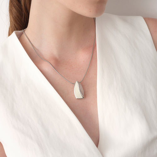 Close-up detail of the textured leather and white tiger's eye pendant necklace, highlighting the unique craftsmanship and premium materials.