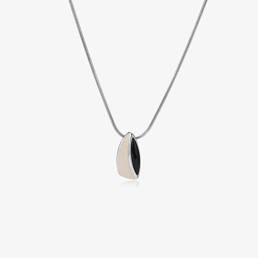 TIKOO original sculptural pendant necklace featuring natural black onyx and white leather inlay.