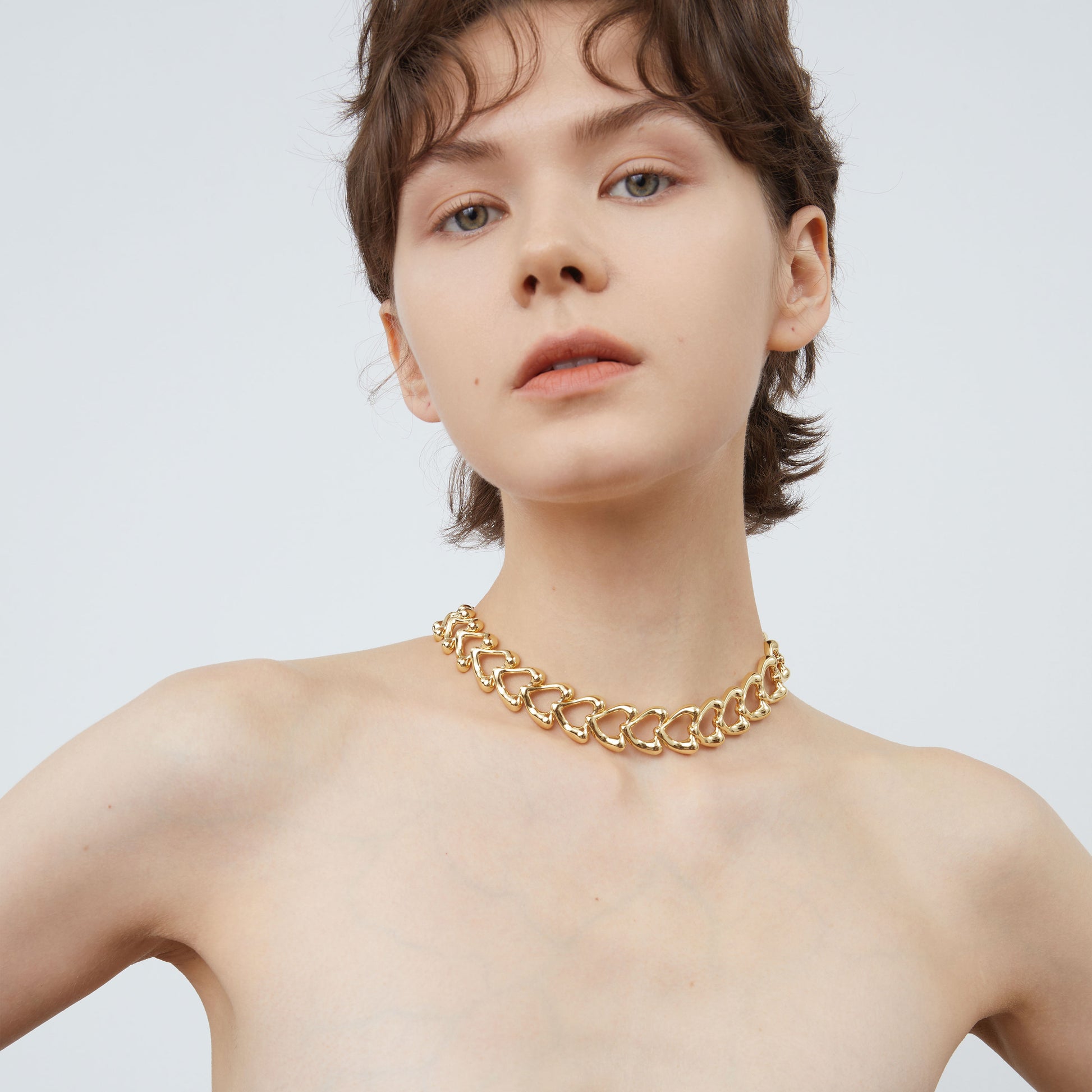 Close-up of the chunky heart-shaped links on the TIKOO gold necklace, highlighting the premium 18K gold plating.