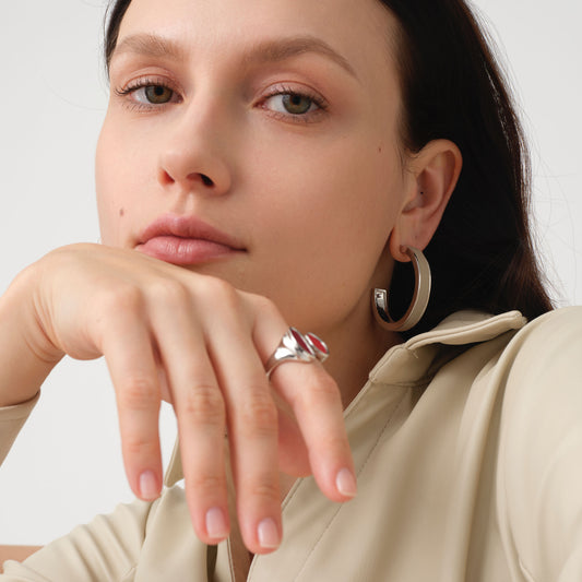 Fashion model wearing TIKOO large beige leather hoop earrings, showcasing the modern minimalist jewelry trend.