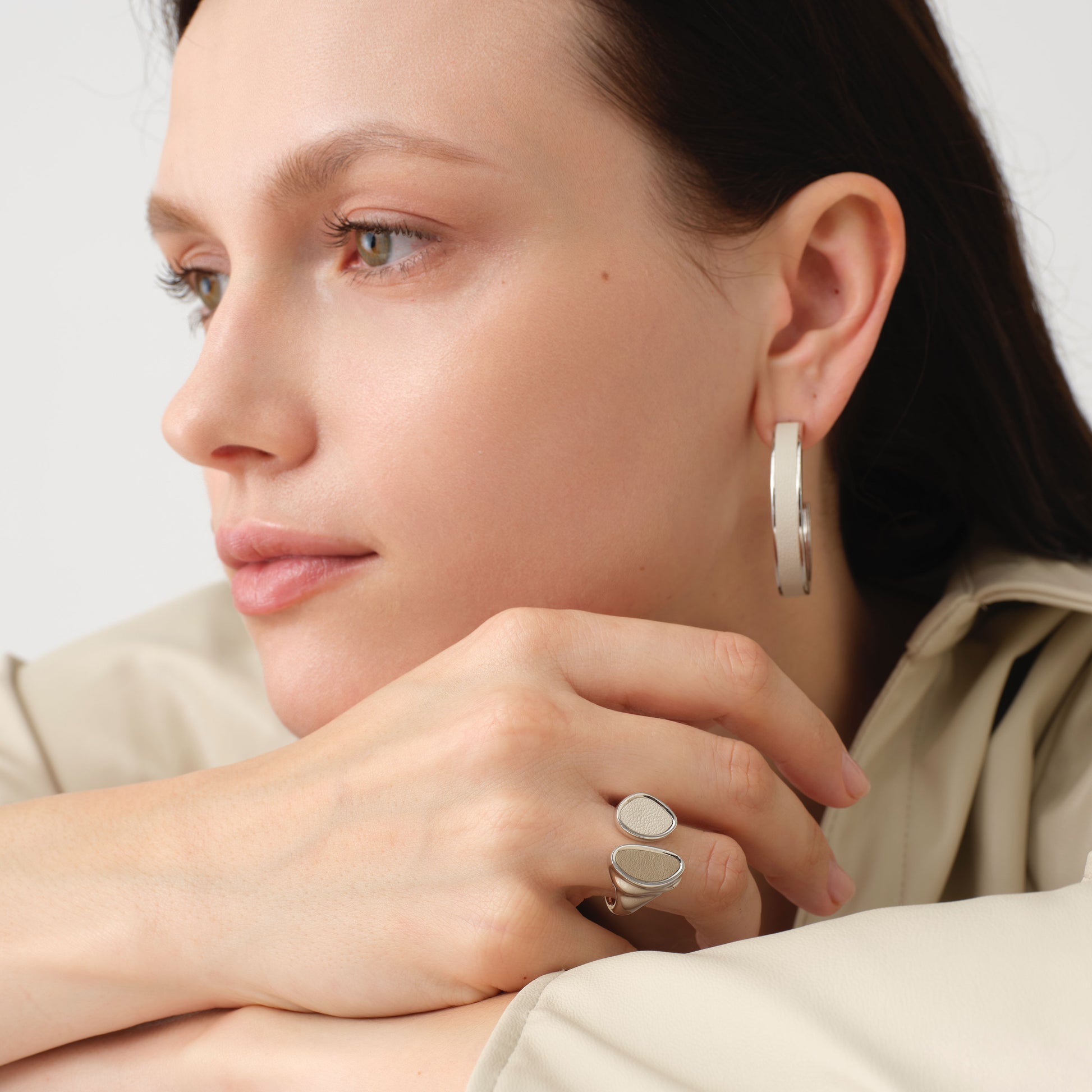 Fashion model wearing TIKOO large white leather hoop earrings, showcasing the clean girl aesthetic and minimalist jewelry trend.