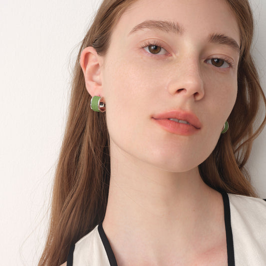 Side view of model wearing TIKOO premium leather inlay earrings, highlighting the textured leather and brilliant silver-tone finish.