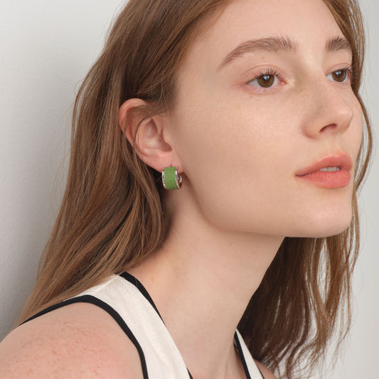Side view of model wearing TIKOO premium leather inlay earrings, highlighting the textured leather and brilliant silver-tone finish.