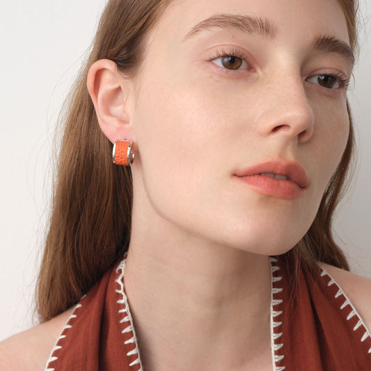Close-up side view of model wearing TIKOO premium leather inlay earrings, highlighting the texture and silver shine.