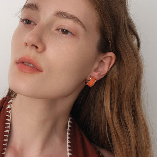 Close-up side view of model wearing TIKOO premium leather inlay earrings, highlighting the texture and silver shine.