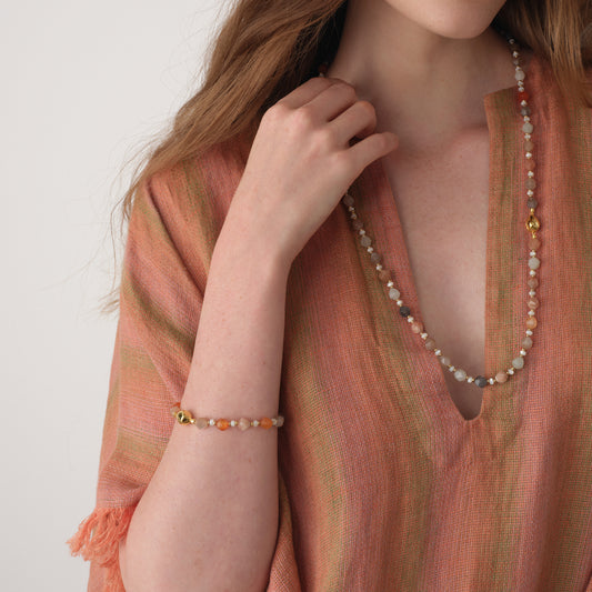 Model styling the TIKOO moonstone bracelet and matching long necklace, highlighting the cohesive look of the natural stone collection.