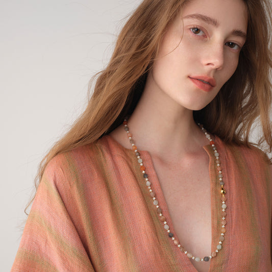 Elegant fashion look featuring the TIKOO original moonstone long necklace with a focus on its luminous natural beads.