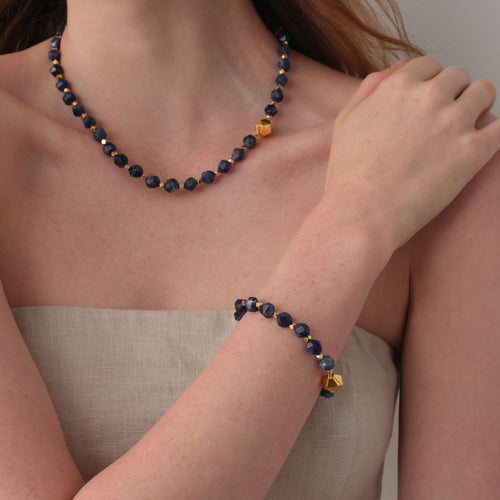Model wearing TIKOO original design sodalite bracelet and matching necklace for a complete jewelry set look.