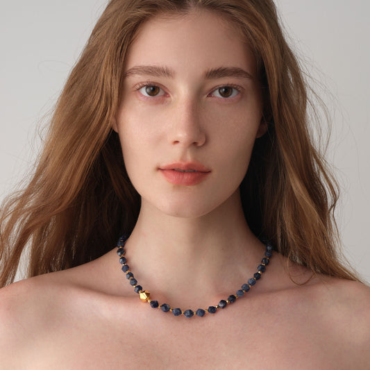 Close-up of a female model wearing the TIKOO Sodalite gemstone necklace, showcasing minimalist jewelry for professional styling.