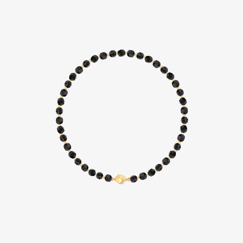 Professional product shot of TIKOO original design black onyx beaded necklace with 18k gold plated geometric accents on a white background.