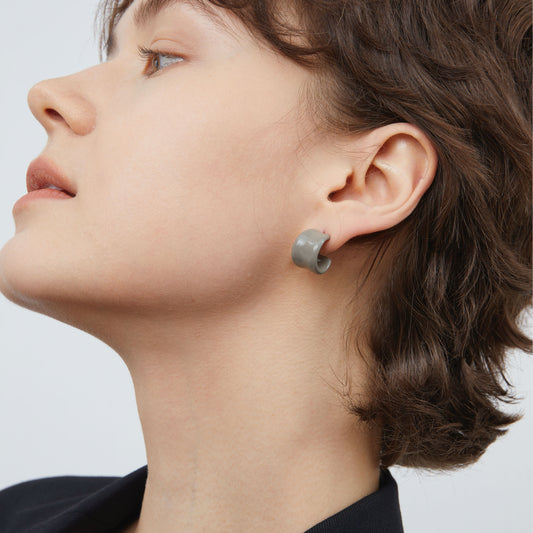 Close-up of TIKOO grey enamel C-shape earrings highlighting the glossy architectural design.
