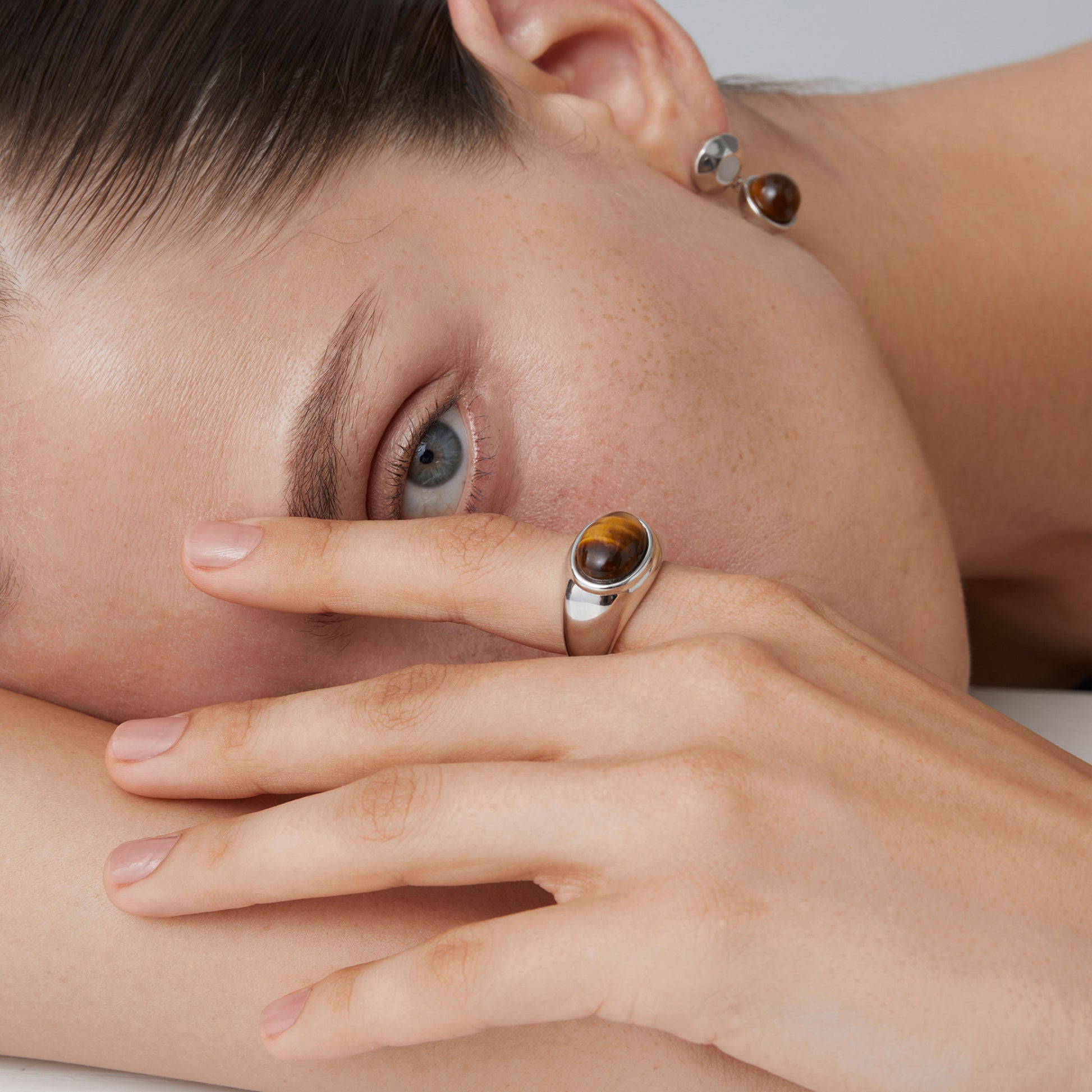Detail view of a high-quality thick white gold plated sterling silver ring featuring a natural tiger's eye stone.
