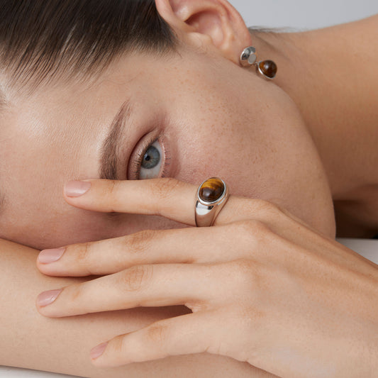 Detail view of a high-quality thick white gold plated sterling silver ring featuring a natural tiger's eye stone.