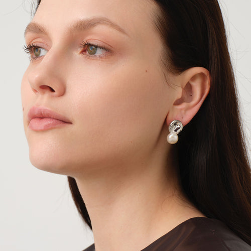 Side view of model wearing TIKOO original natural pearl and white gold plated earrings for a chic fashion look.