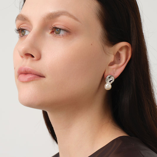 Side view of model wearing TIKOO original natural pearl and white gold plated earrings for a chic fashion look.