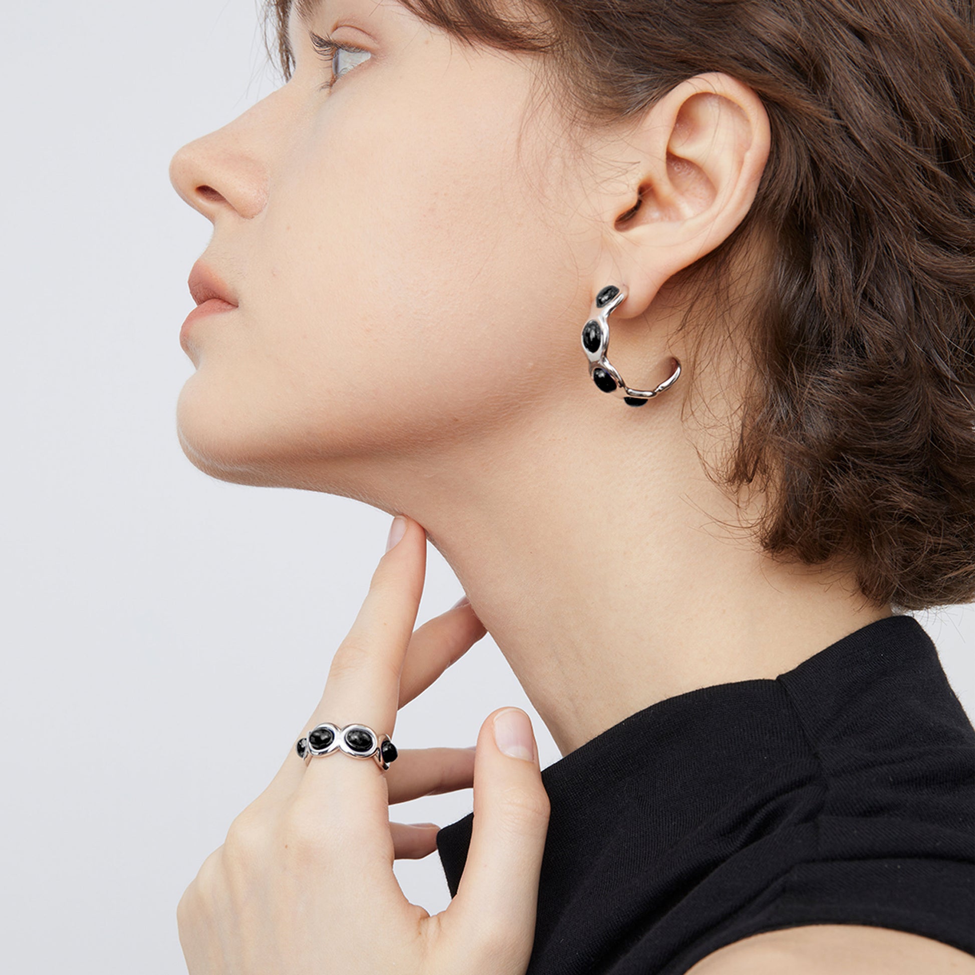 Close-up of the adjustable TIKOO black onyx ring, showing the high-shine finish and stone detail.