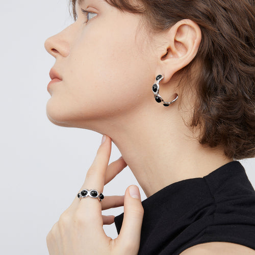 Close-up of the adjustable TIKOO black onyx ring, showing the high-shine finish and stone detail.