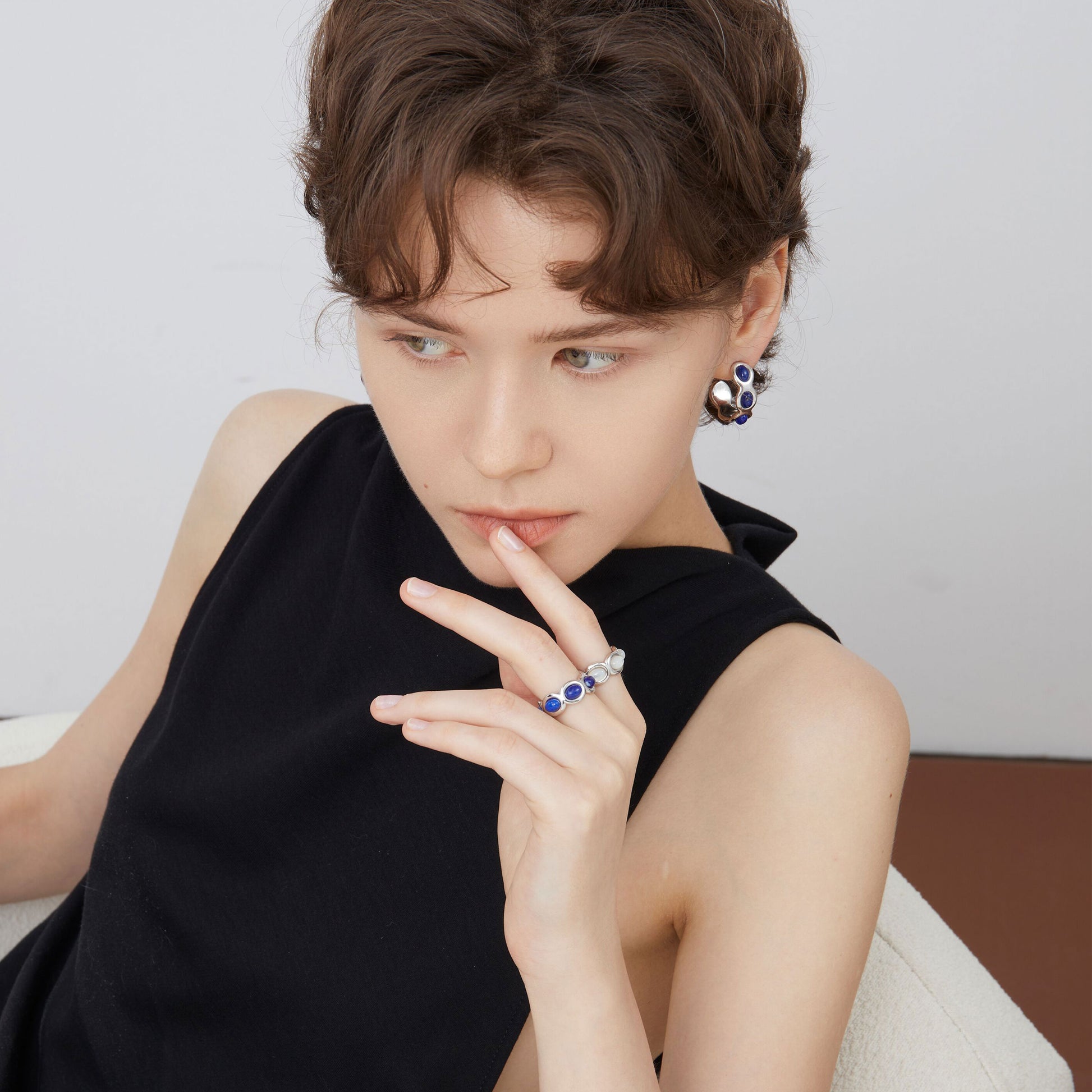 Close-up view of a model wearing the TIKOO blue lapis wave ring, highlighting the vibrant stone color.