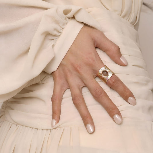 Lifestyle shot of a woman wearing the TIKOO wide band smoky quartz ring, highlighting earthy jewelry style.