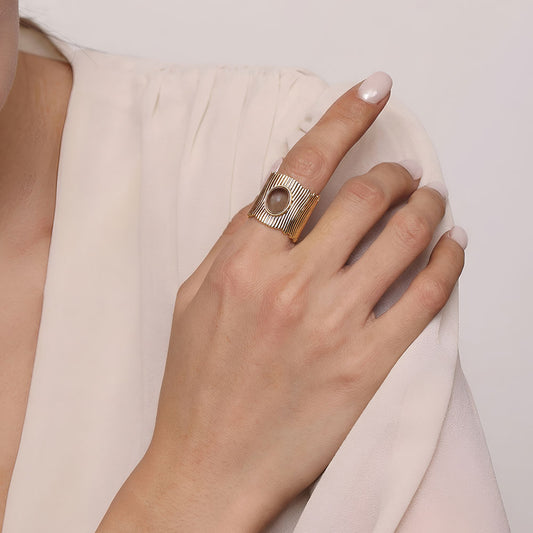 Lifestyle shot of a woman wearing the TIKOO wide band smoky quartz ring, highlighting earthy jewelry style.