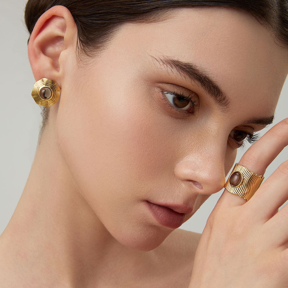 Lifestyle shot of a woman wearing the TIKOO wide band smoky quartz ring, highlighting earthy jewelry style.
