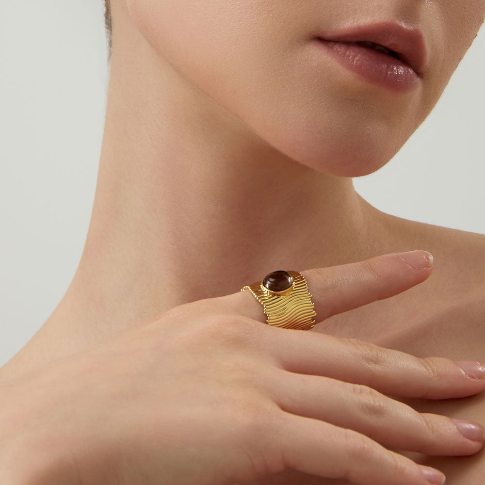 Lifestyle shot of a woman wearing the TIKOO wide band smoky quartz ring, highlighting earthy jewelry style.