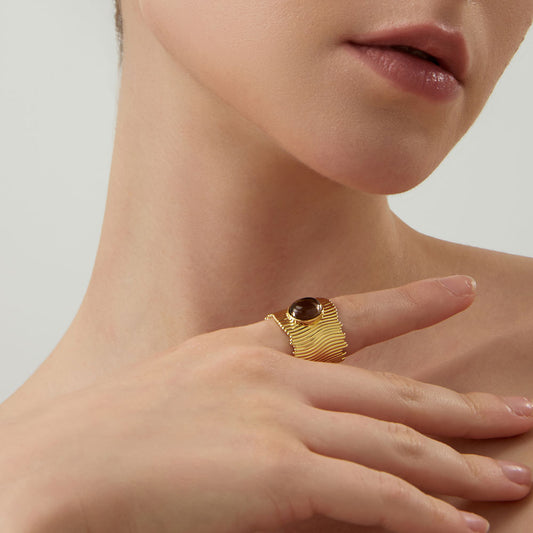 Lifestyle shot of a woman wearing the TIKOO wide band smoky quartz ring, highlighting earthy jewelry style.