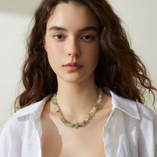Professional model showcasing the TIKOO prehnite beaded necklace, styled with a minimalist white linen shirt for a modern everyday look.