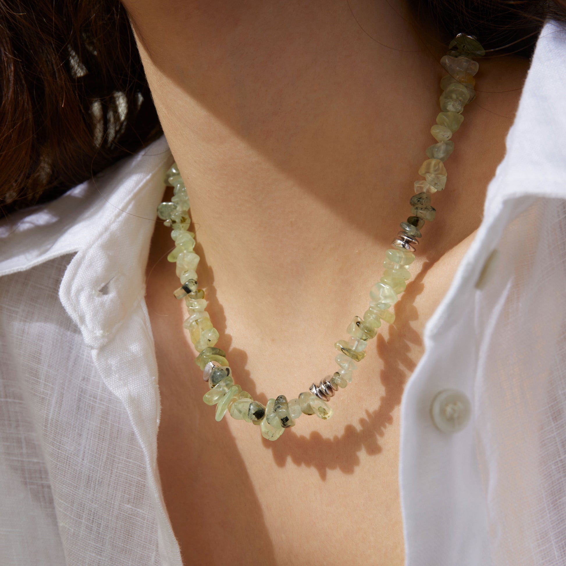 Professional model showcasing the TIKOO prehnite beaded necklace, styled with a minimalist white linen shirt for a modern everyday look.